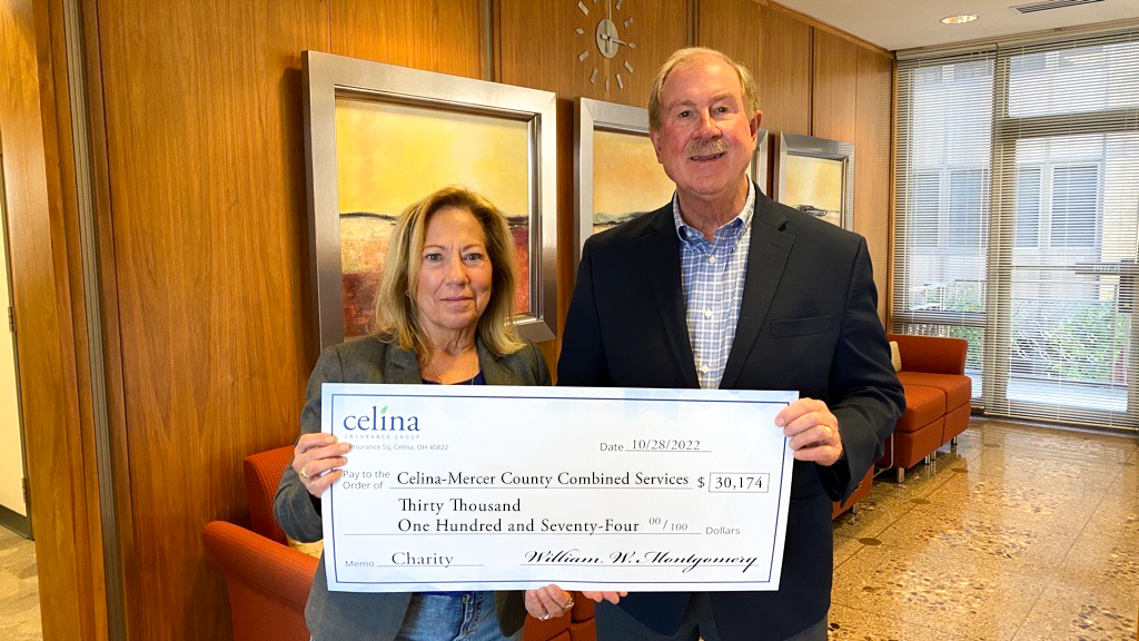 Celina Insurance Group President and CEO Bill Montgomery, right, presents a check to Celina-Mercer County Combined Services Appeal Vice President Cathy Bigham.