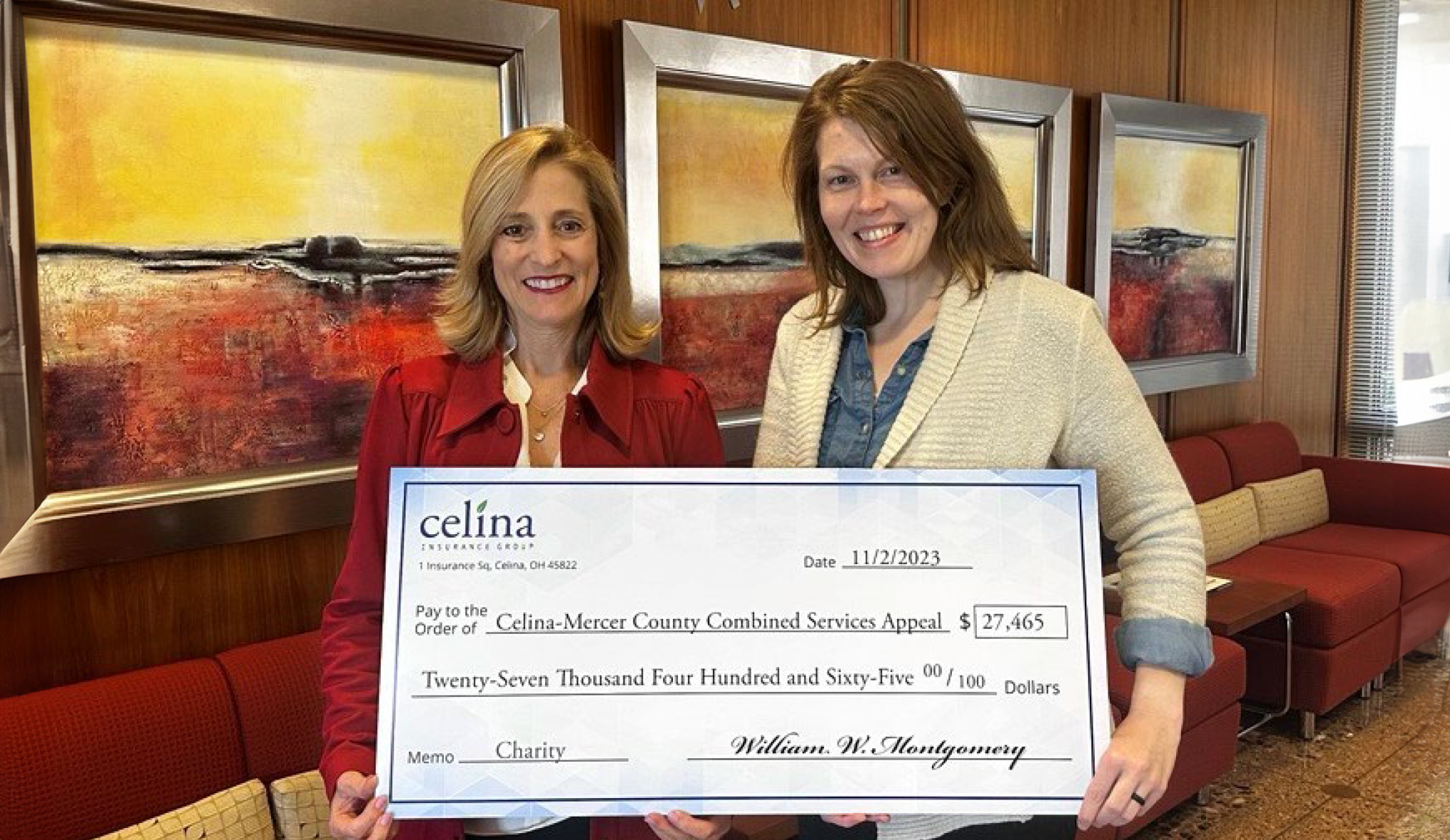 Christine Purdy, Director of Human Resources and Facilities, and Caitlin Bair, Compliance Manager smile with a combined services check donation.