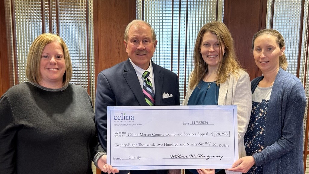 A group of Celina Insurance Group representatives hold a large check made out to the Celina-Mercer County Combined Services Appeal.