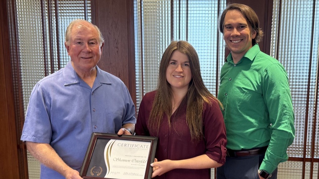 Celina Insurance Group President and CEO Bill Montgomery (left) and Senior Actuarial and Data Science Manager Jake Eilerman (right) present a certificate to Actuary Shannon Osterfeld in honor of her Fellow of the Casualty Actuarial Society (FCAS) designation achievement.